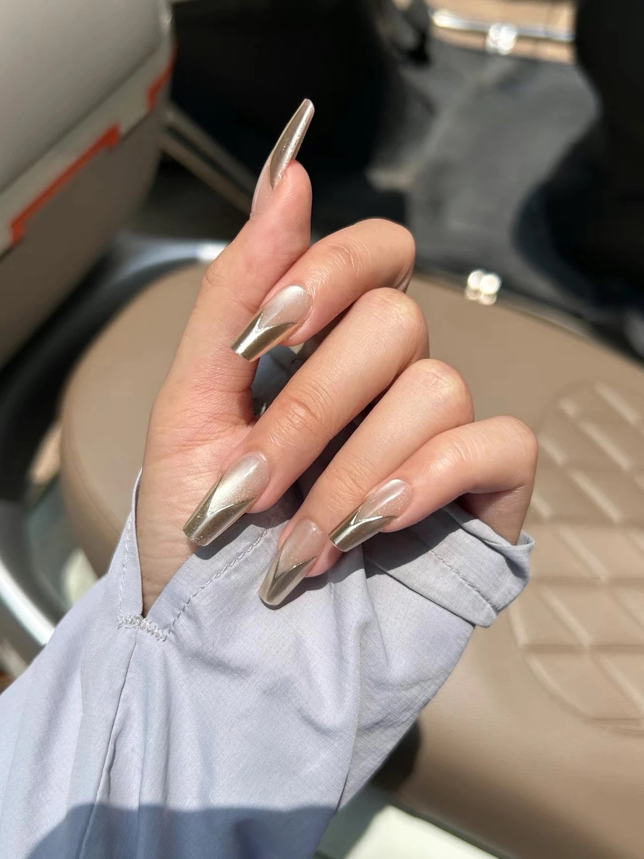 Coffin Nail Design – Nude Base with Metallic Gold V-Tips